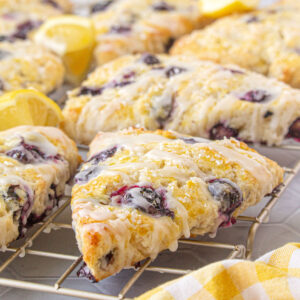 Closeup of blueberry scones on a rack for feature image.