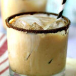 A creamy coffee cocktail in a glass with title text overlay for Pinterest.