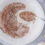 Overhead view of a white bowl with a seasoning mix in it.