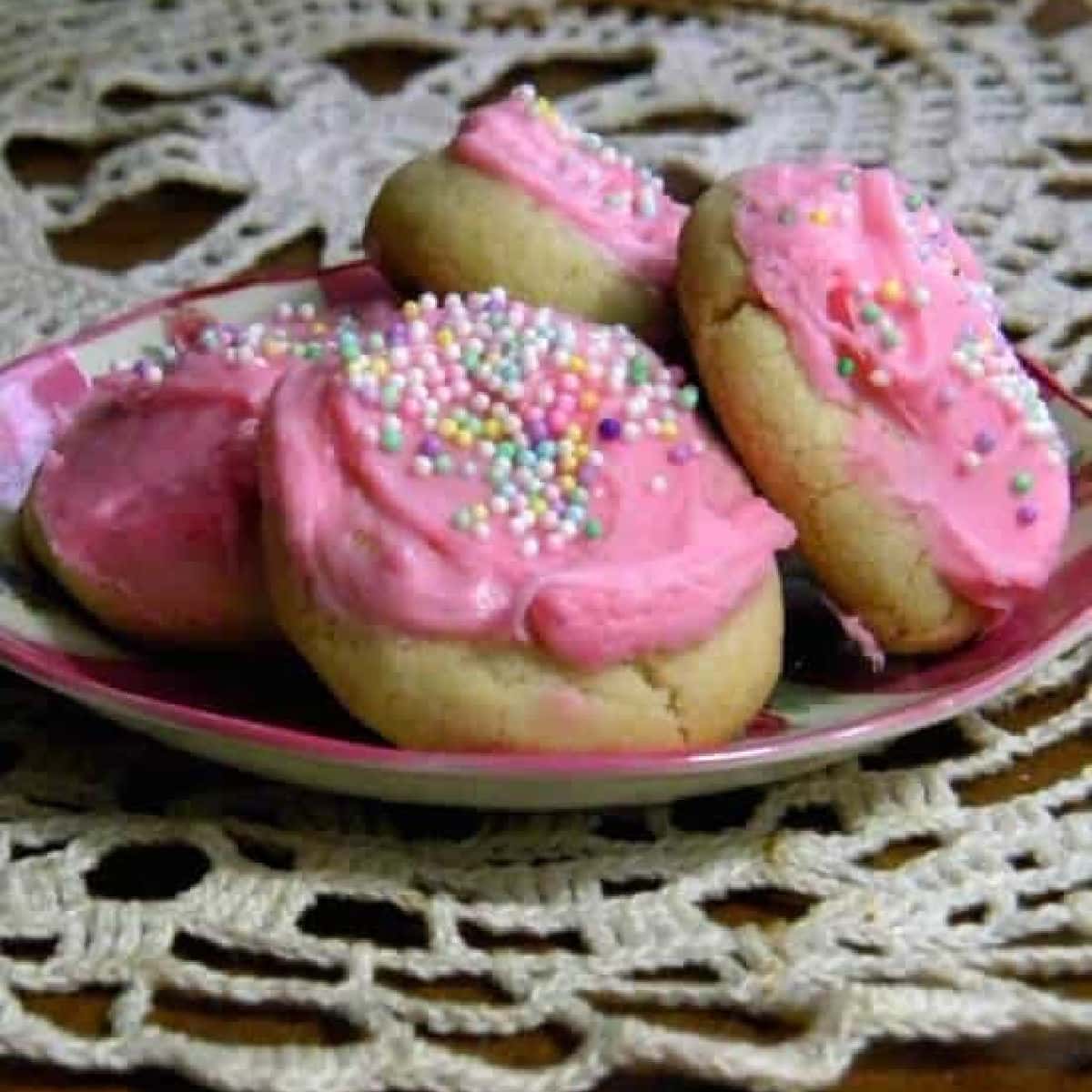 Closeup of soft sugar cookies with pink icing.