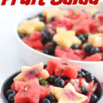 Fruit salad in a dark bowl with title text overlay for Pinterest.