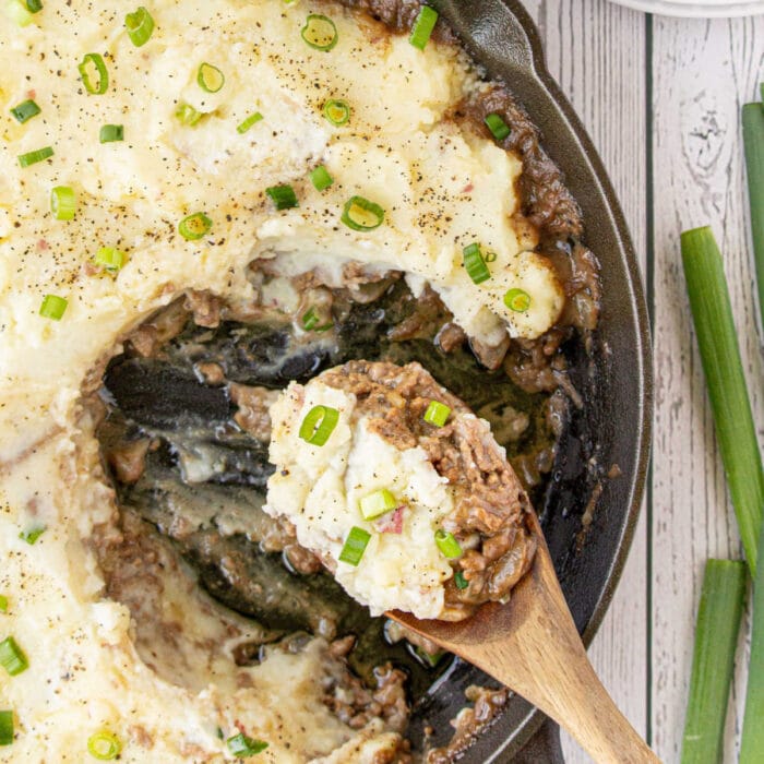 Closeup of a serving spoon filled with the casserole for the recipe's feature image.