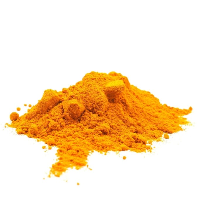 Ground turmeric on a white background.