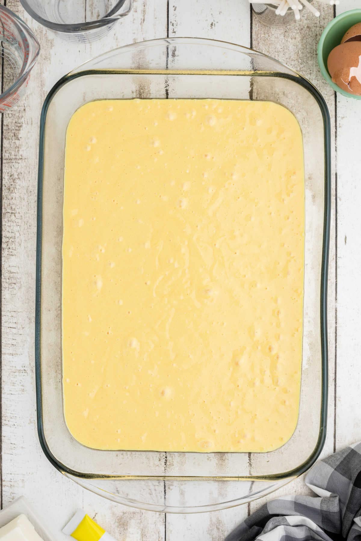 Batter in a cake pan ready to be baked.