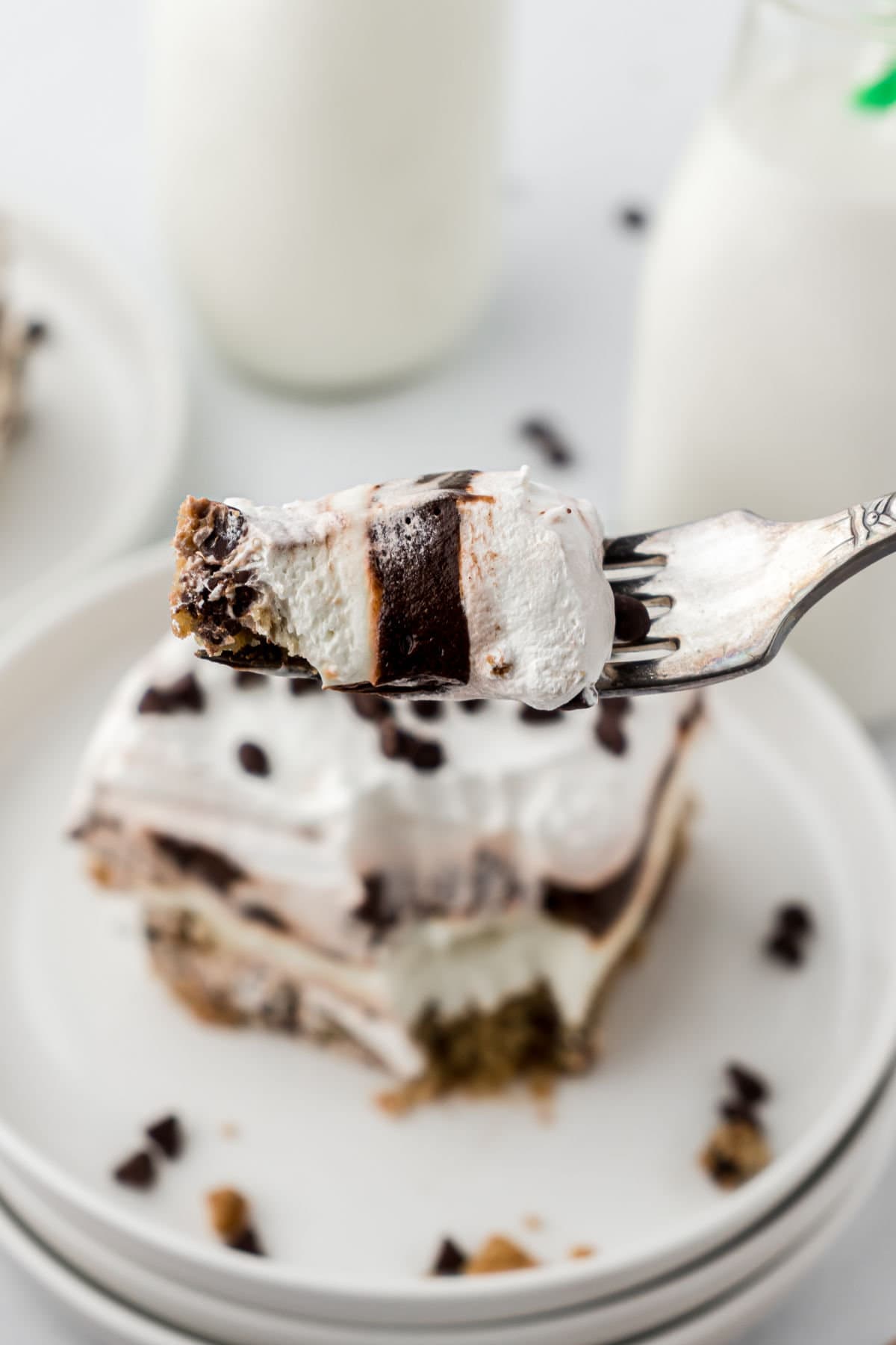 A fork lifting up a bite of dessert.