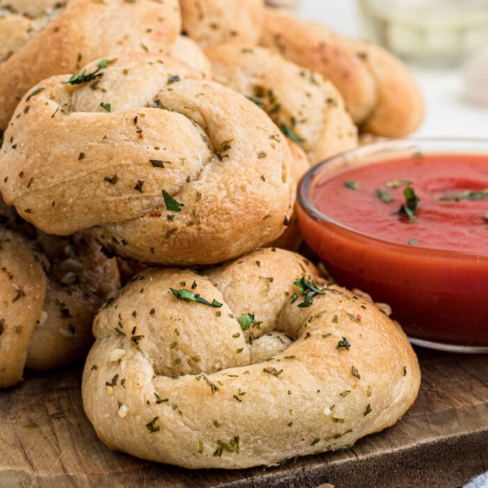 Closeup of the garlic rolls next to marinara sauce.