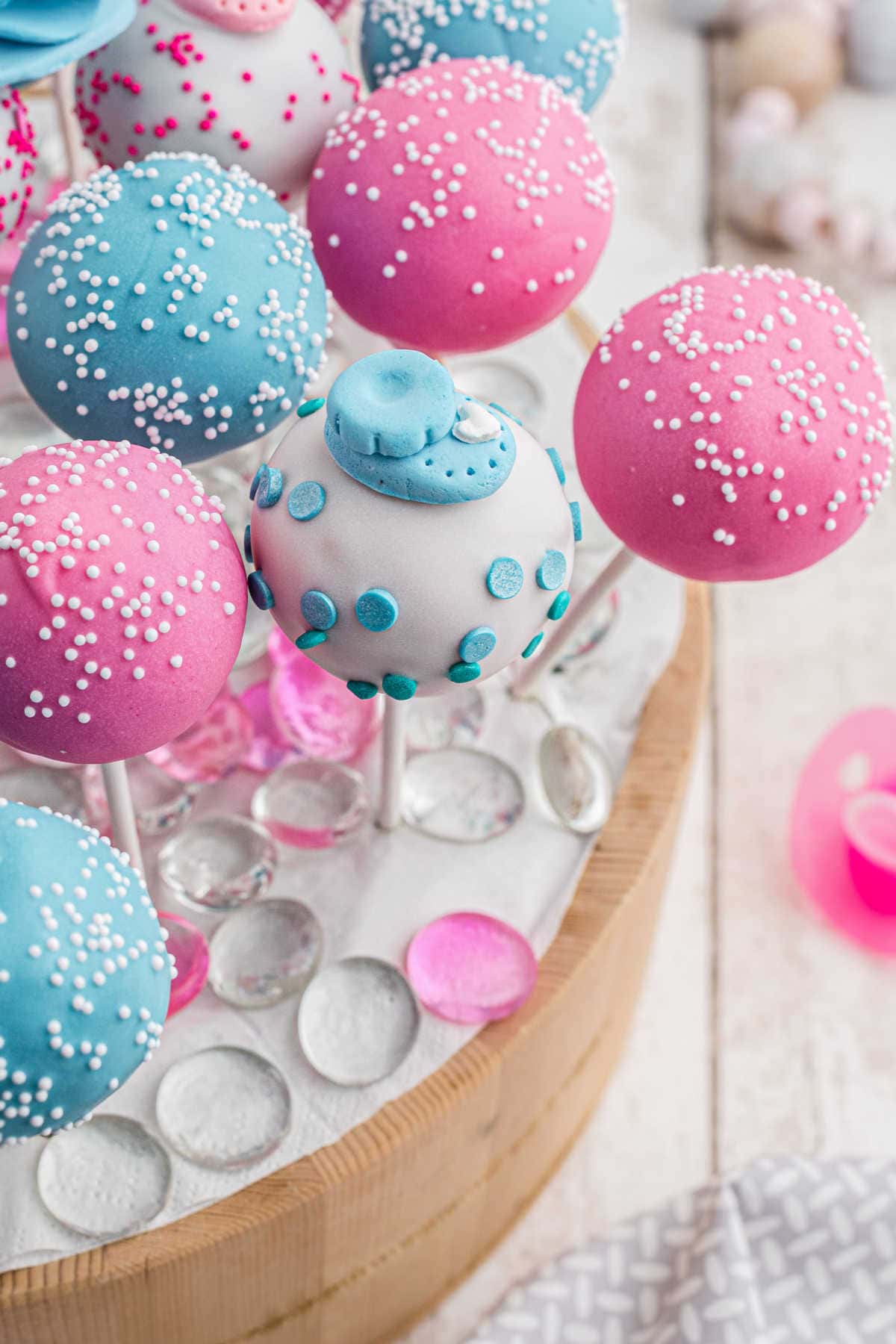 Close-up look at the decorations on the blue and pink cake pops.