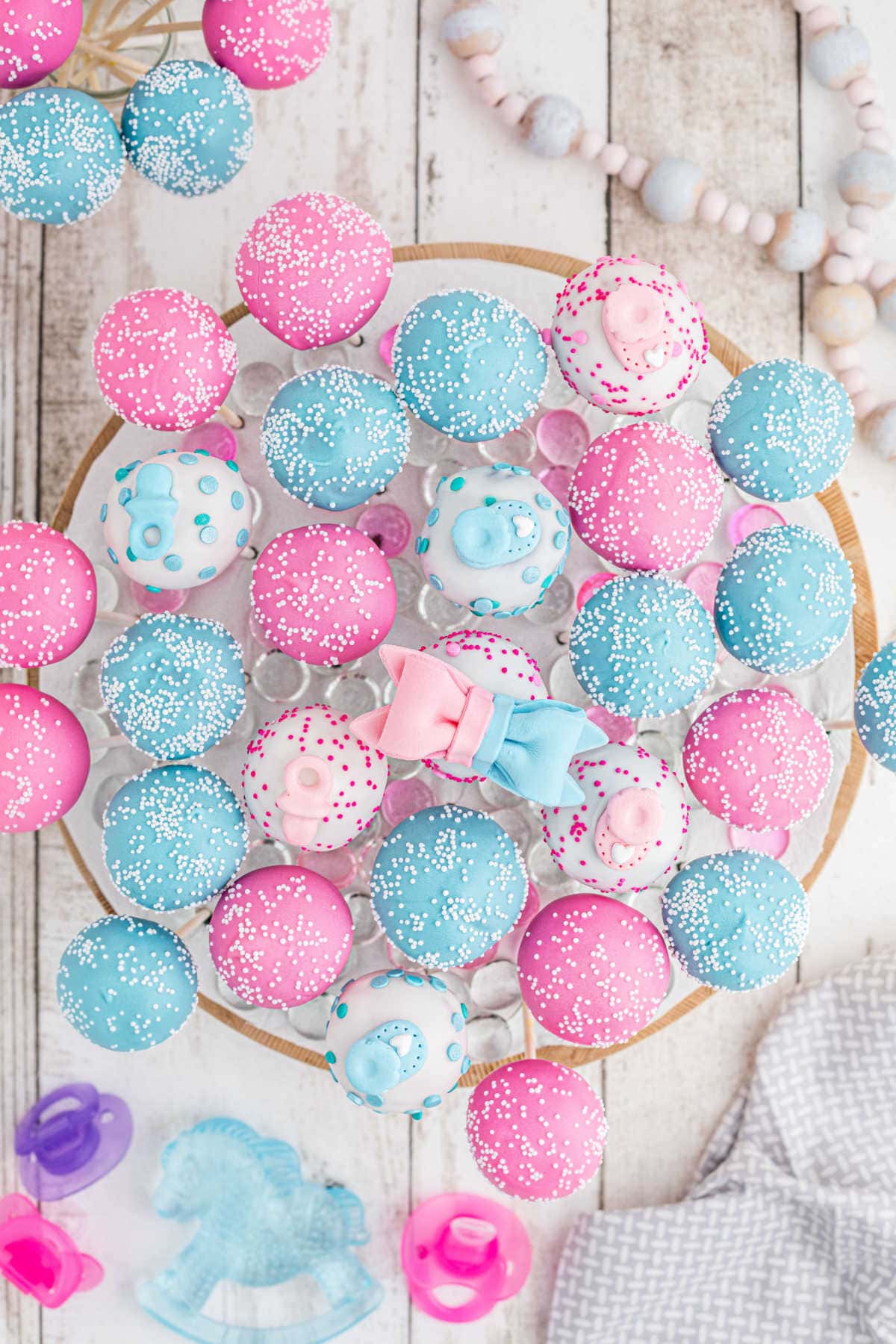 Overhead view of pink and blue cake pops.