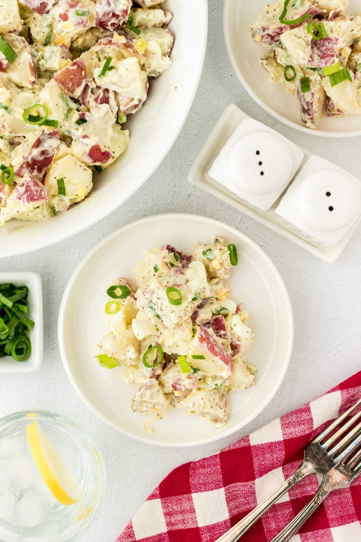 Overhead view of a bowl of potato salad on a table.