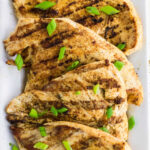 Overhead view of finished chicken with grill marks.