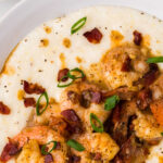 Overhead view of shrimp and grits in a bowl with text overlay for Pinterest.