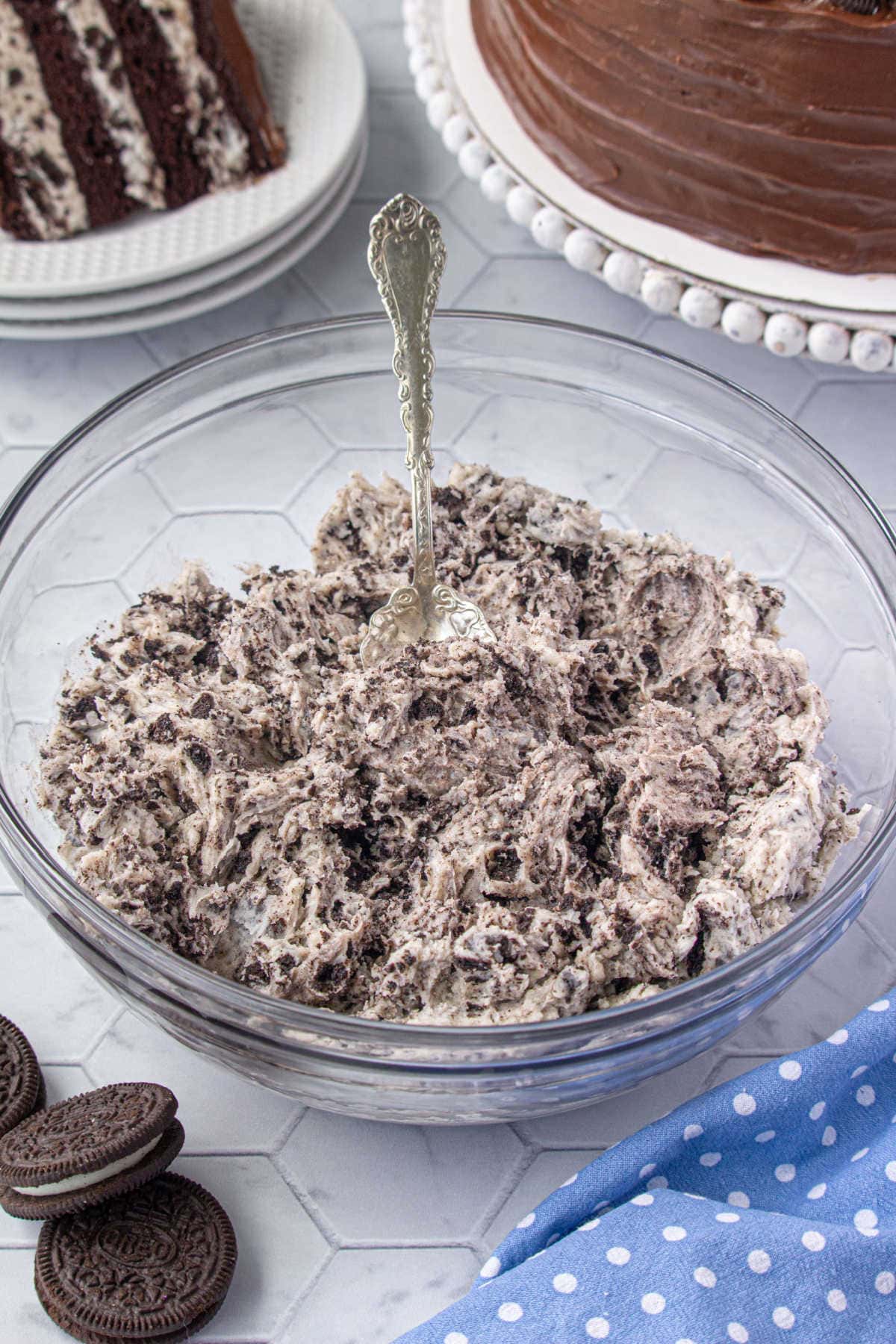 Cookies and cream cake in a bowl next to a finished cake.