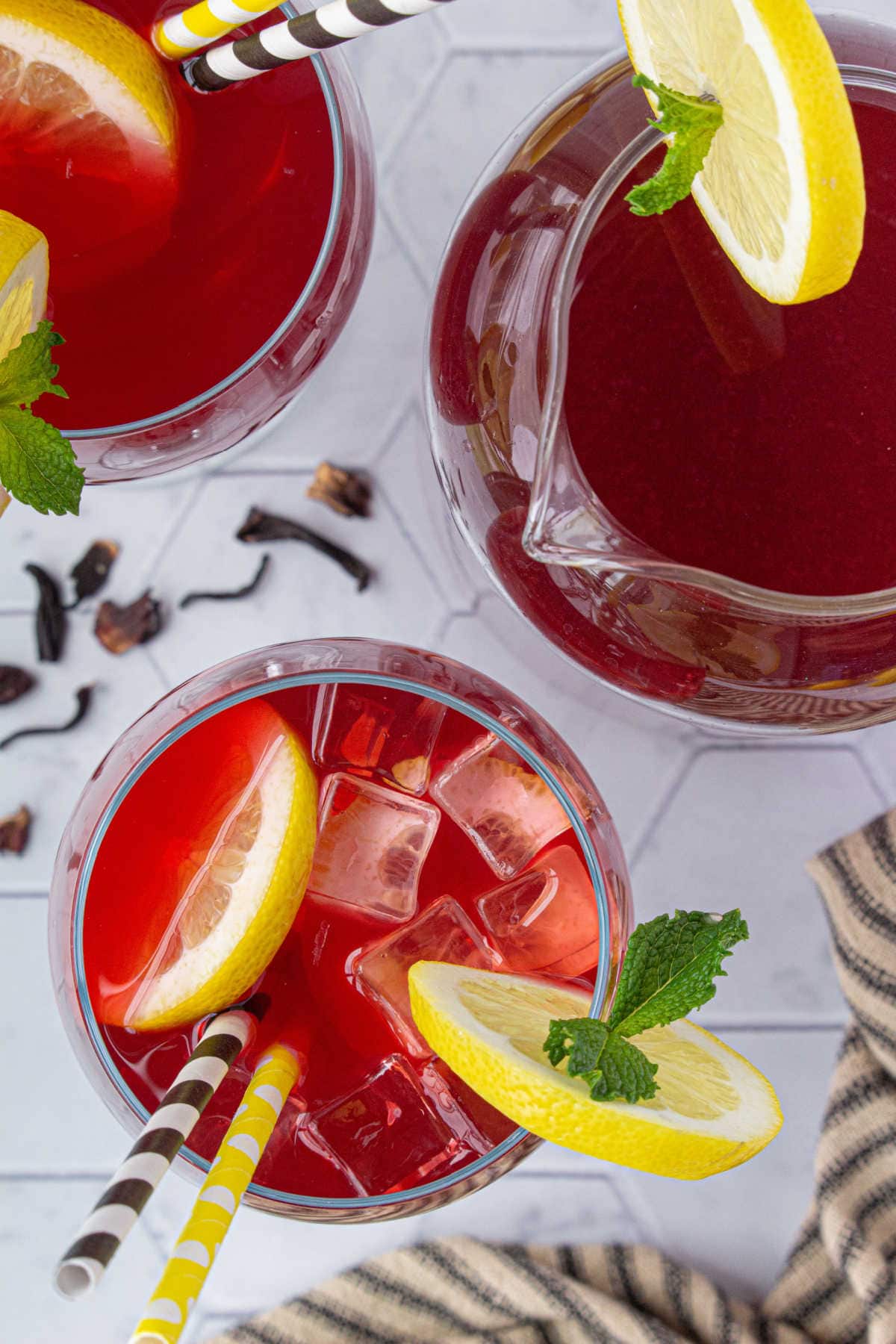 Overhead view of a pitcher and glasses of the lemonade.