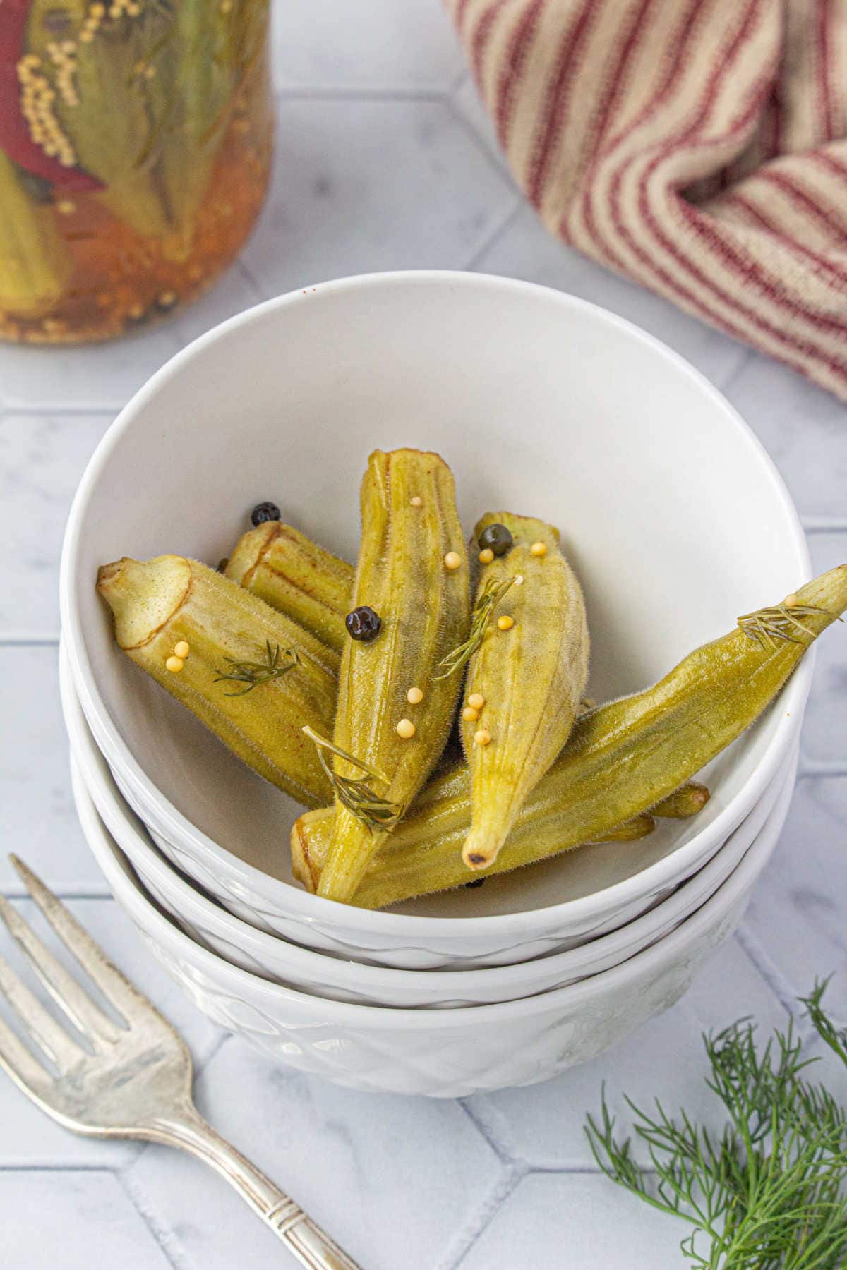 Pickled okra pods in a bowl