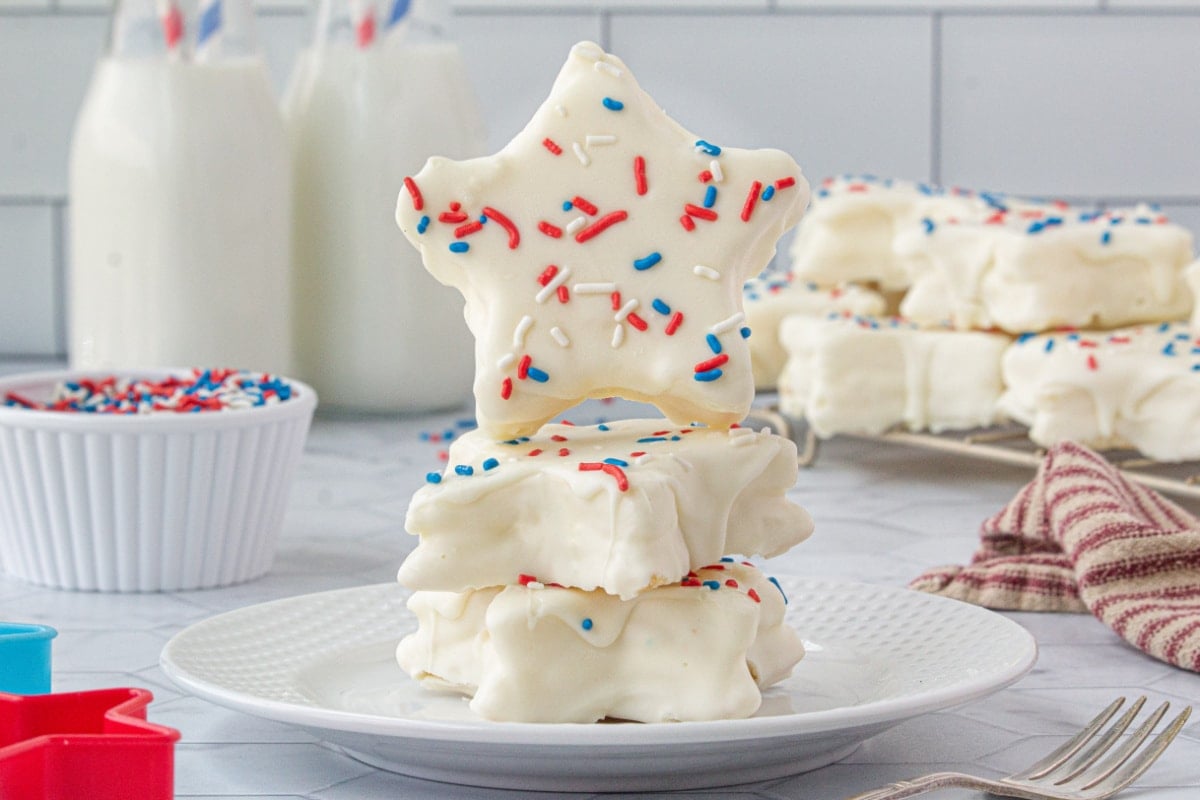 A stack of copycat zebra cakes, cut into star shapes, on a white plate.