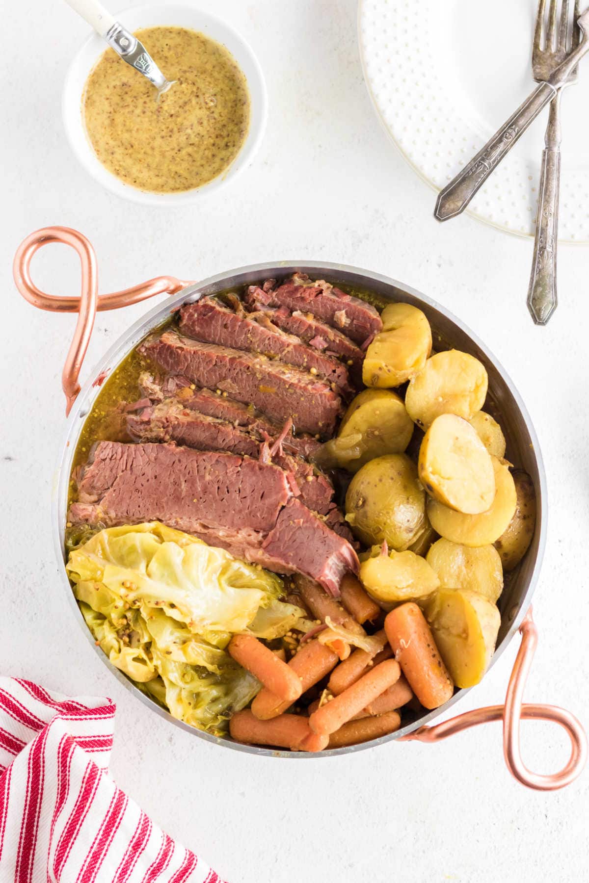 Overhead view of corned beef and vegetables in a serving dish.