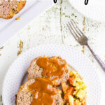 Meatloaf on a plate with a text overlay for Pinterest.