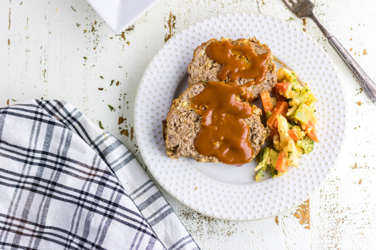 Meatloaf slices on a white plate.