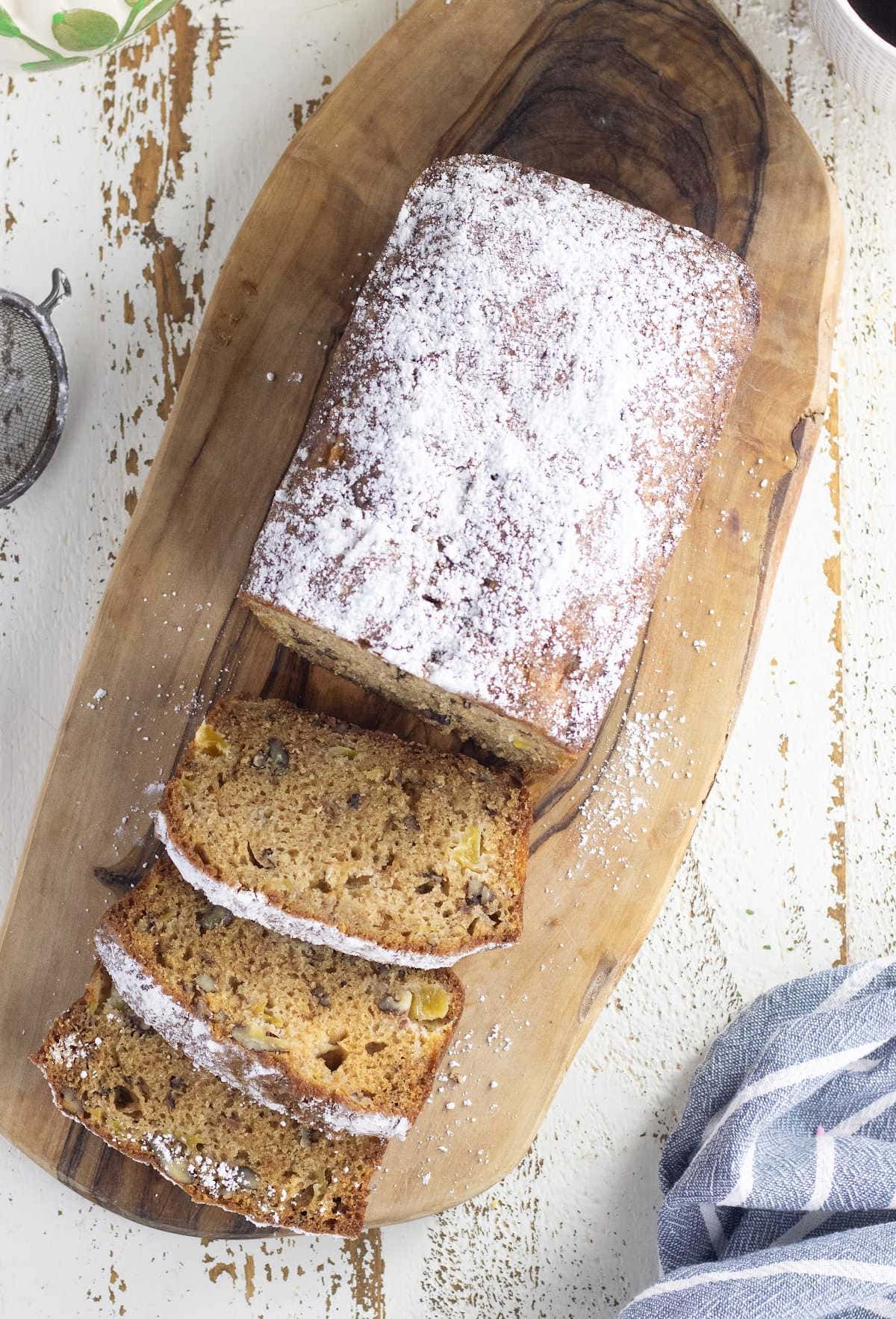 Overhead view of sliced bread with powdered sugar crust.