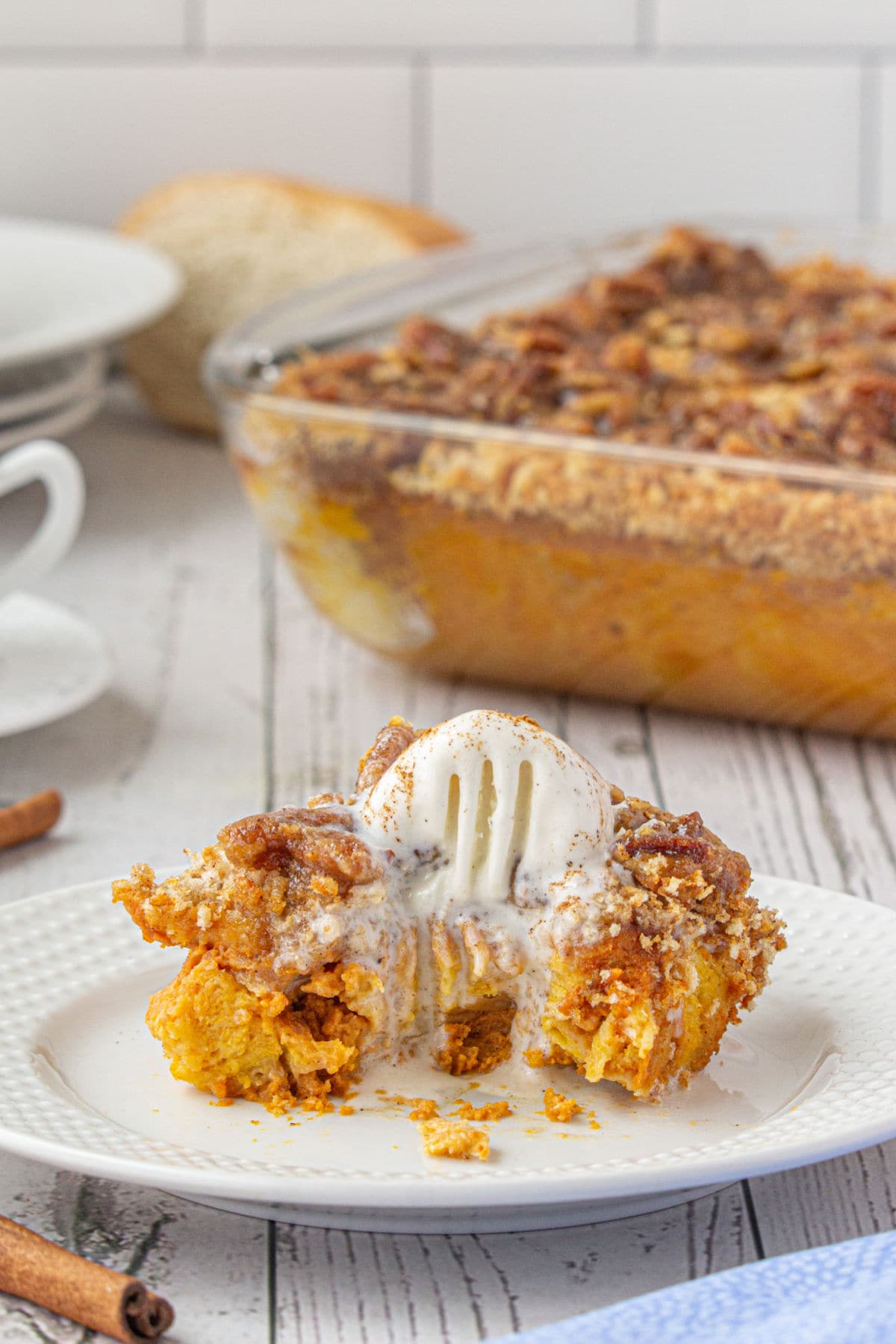 Warm orange pumpkin bread pudding with melting ice cream on top.