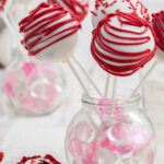 Decorated red velvet cake pops with text overlay for Pinterest.