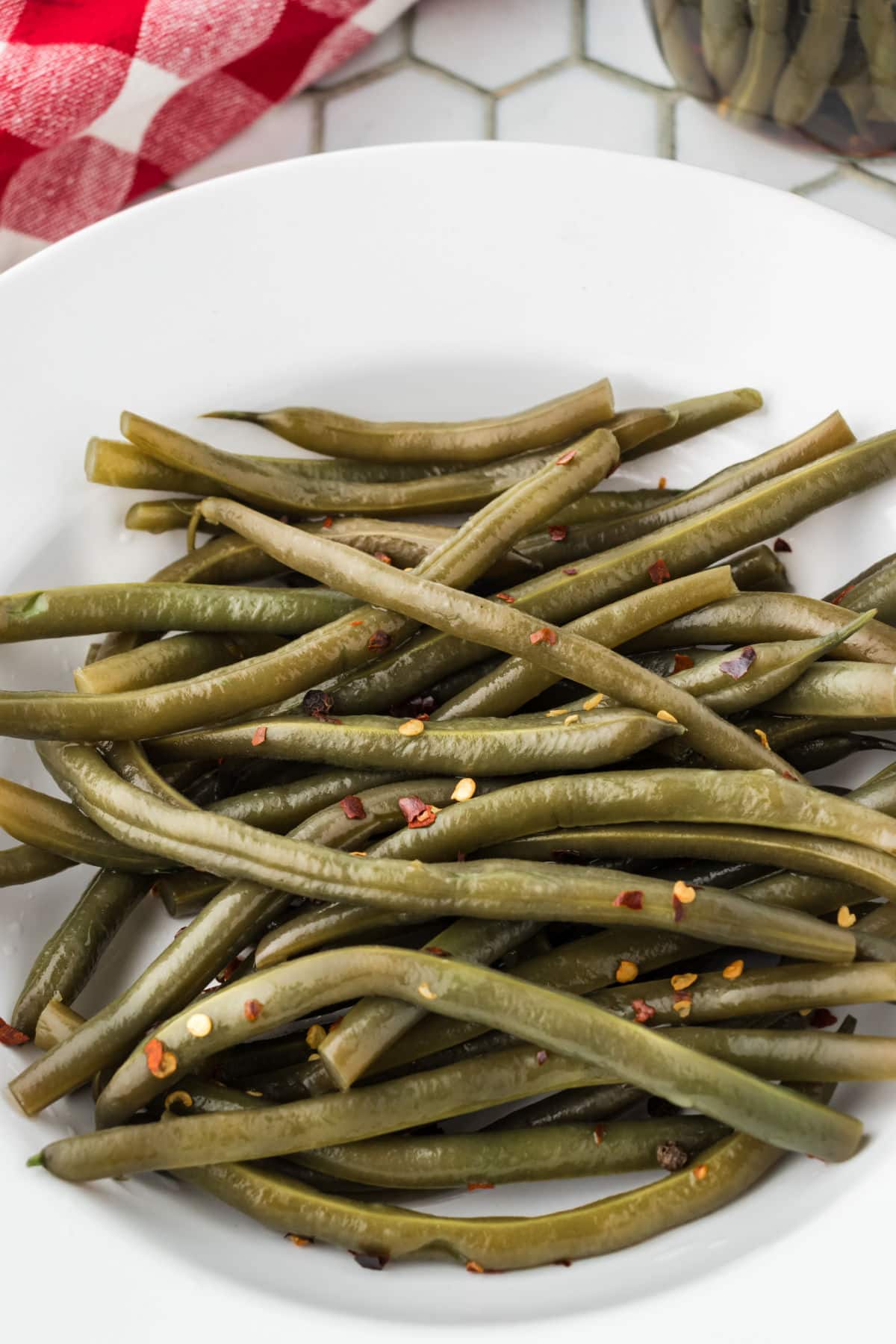 Pickled green beans in a white serving bowl.