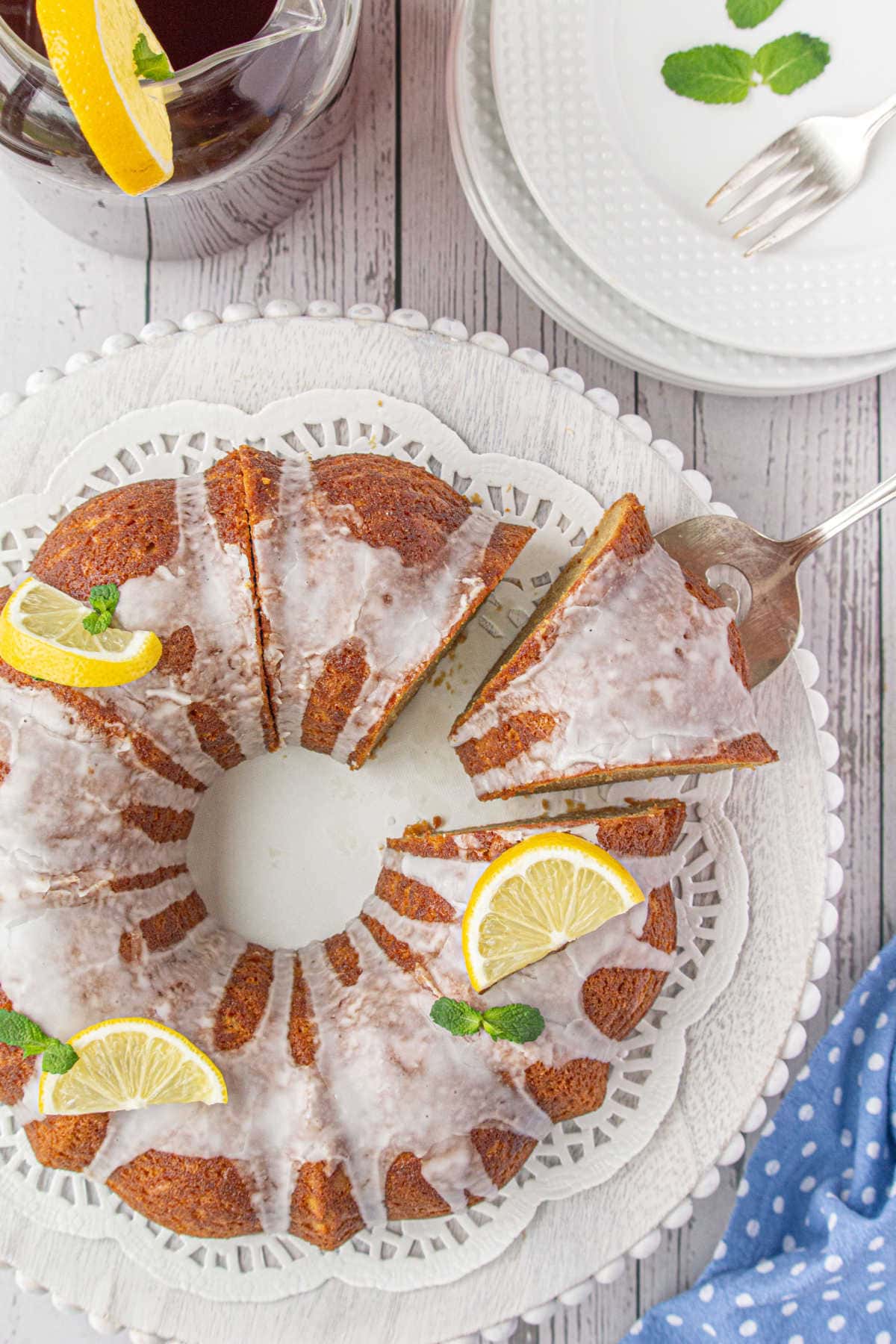 Overhead view of the cake with a lemon garnish on a cake plate.