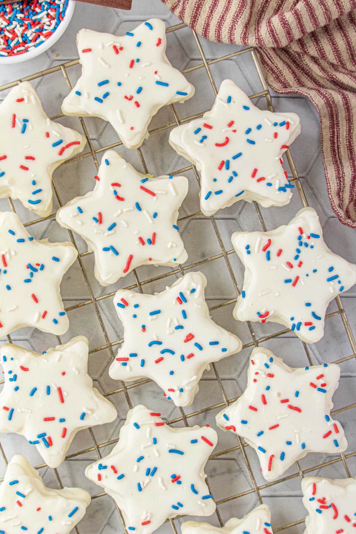 Overhead view of finished cakes decorated with red white and blue sprinkles.