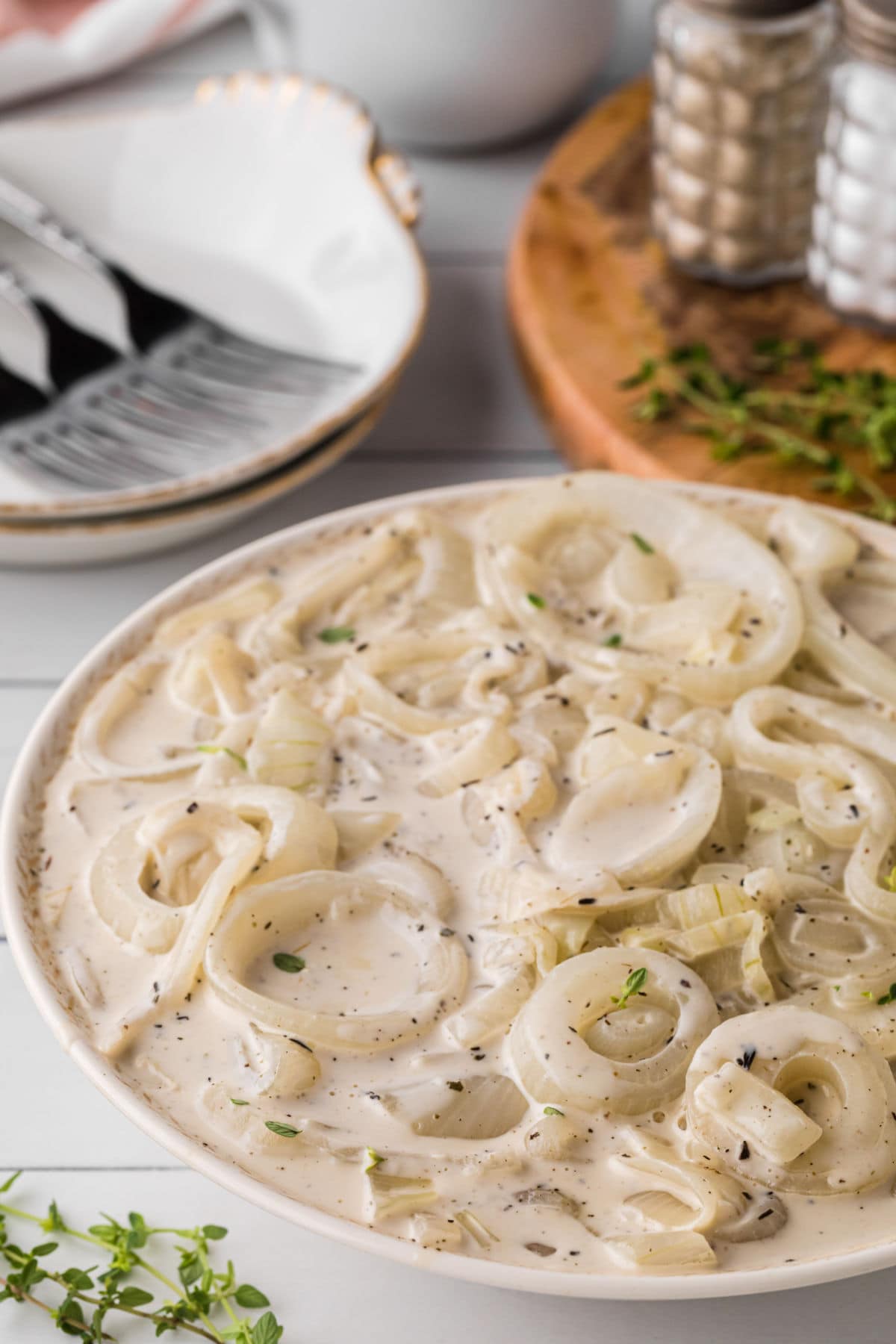 A bowl of creamed onions on a table.