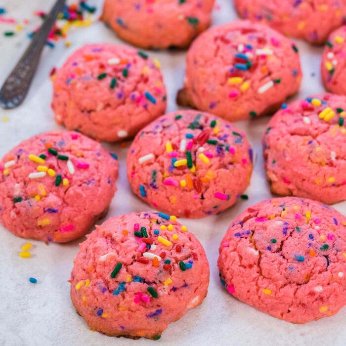 Bright pink cookies with sprinkles.