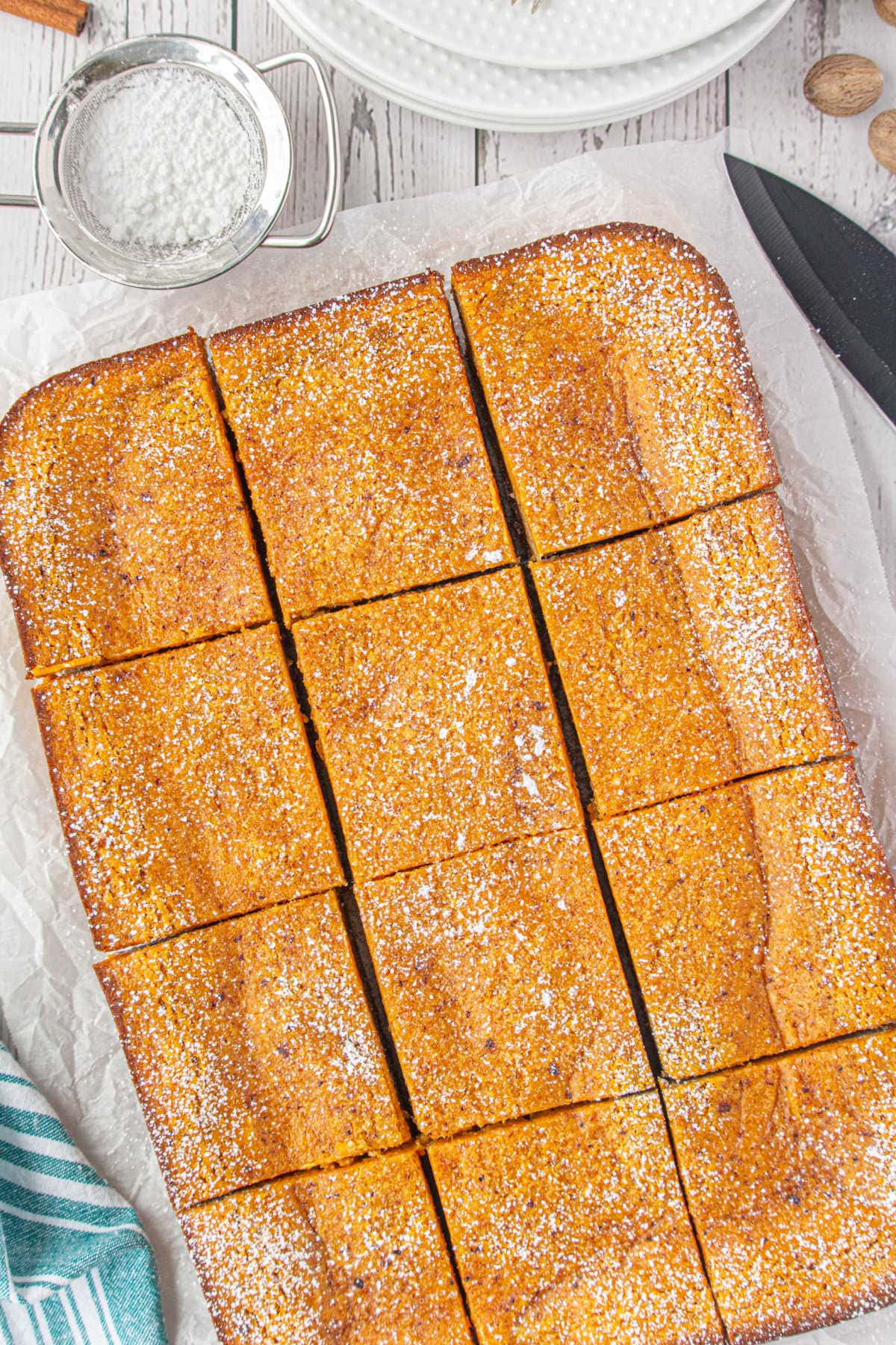 Pumpkin bars being cut into bars.