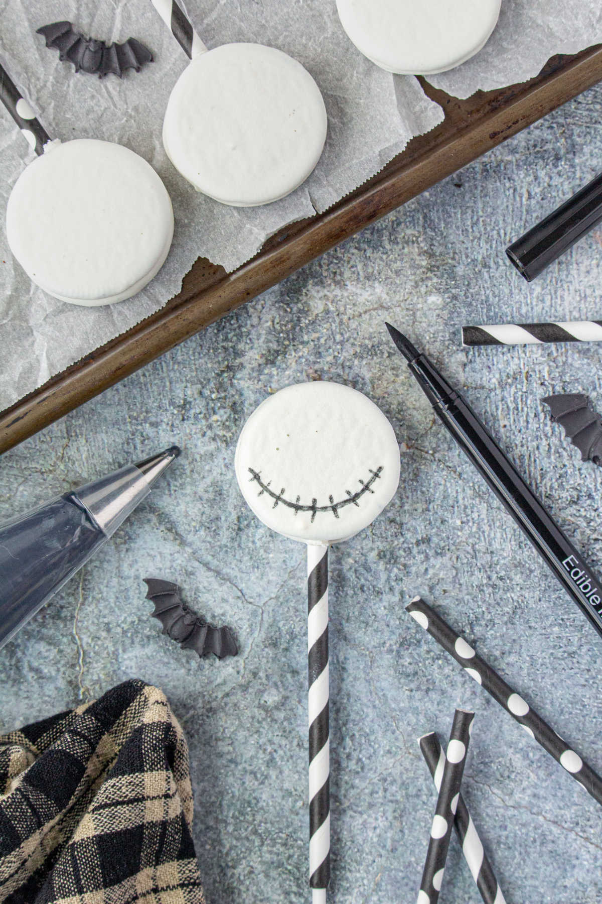 Drawing the mouth on the chocolate covered Oreos.