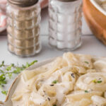 Closeup of a bowl of creamed onions with a text overlay for Pinterest.