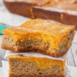 A stack of gooey pumpkin bars with text overlay for Pinterest.