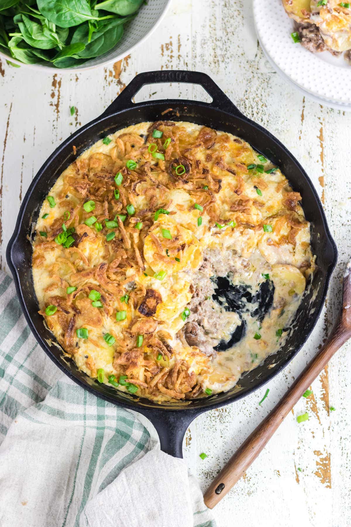 Overhead view of the. casserole with a serving removed showing the creamy sauce that's left in the pan.