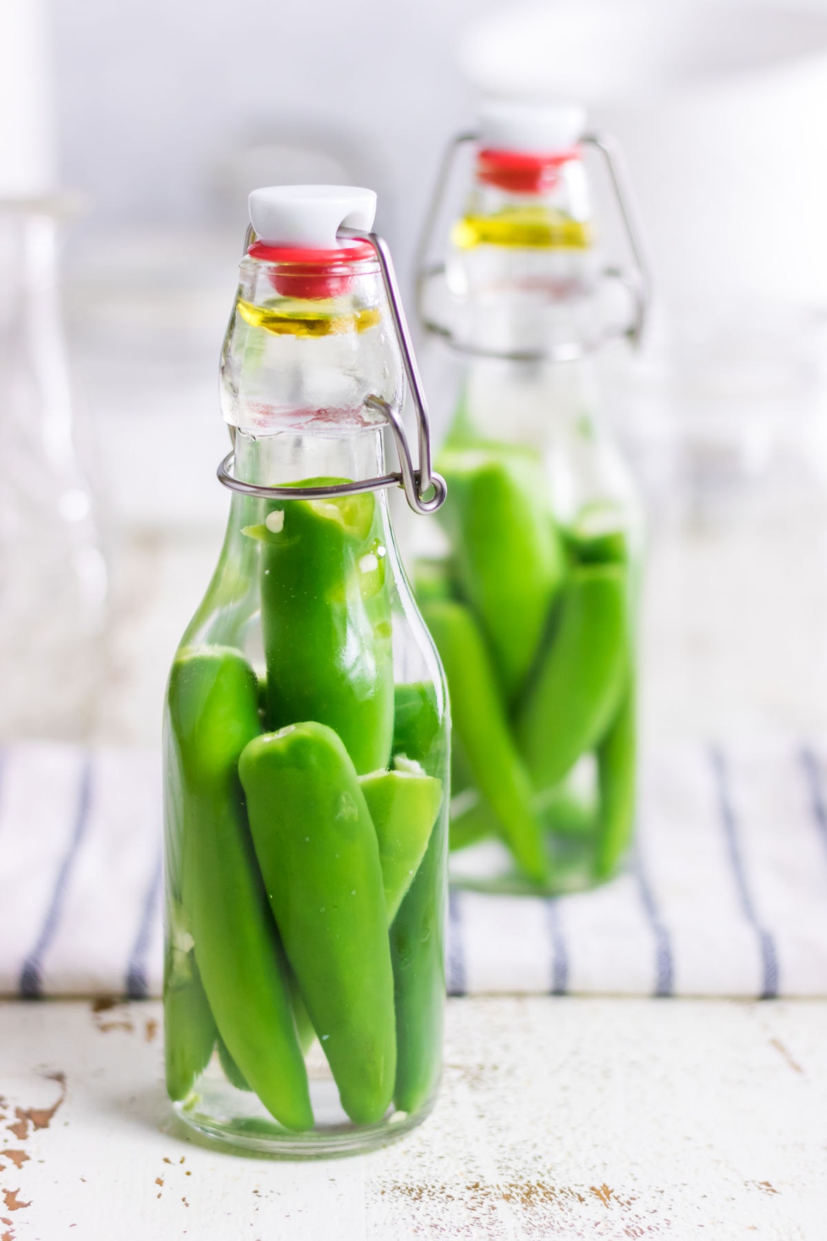 Finished bottles of hot pepper vinegar on a table.