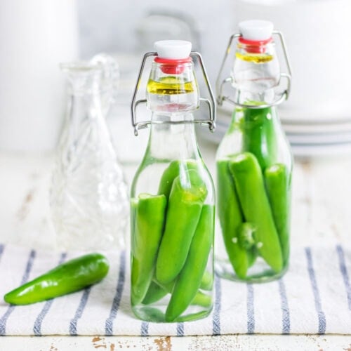 Close up of hot pepper vinegar in jars.