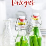 two jars of hot pepper vinegar with a text overlay for Pinterest.