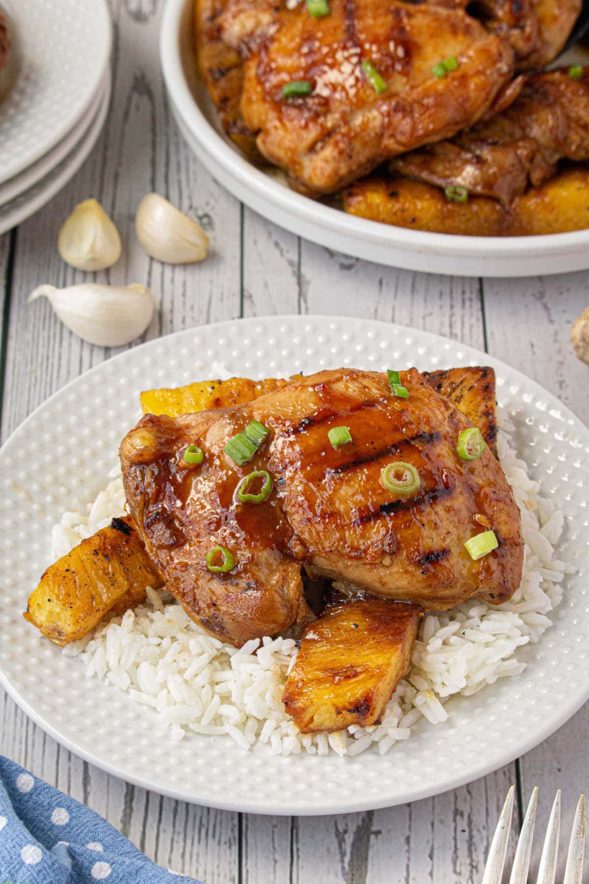 Finished chicken and grilled pineapple on top of white rice.