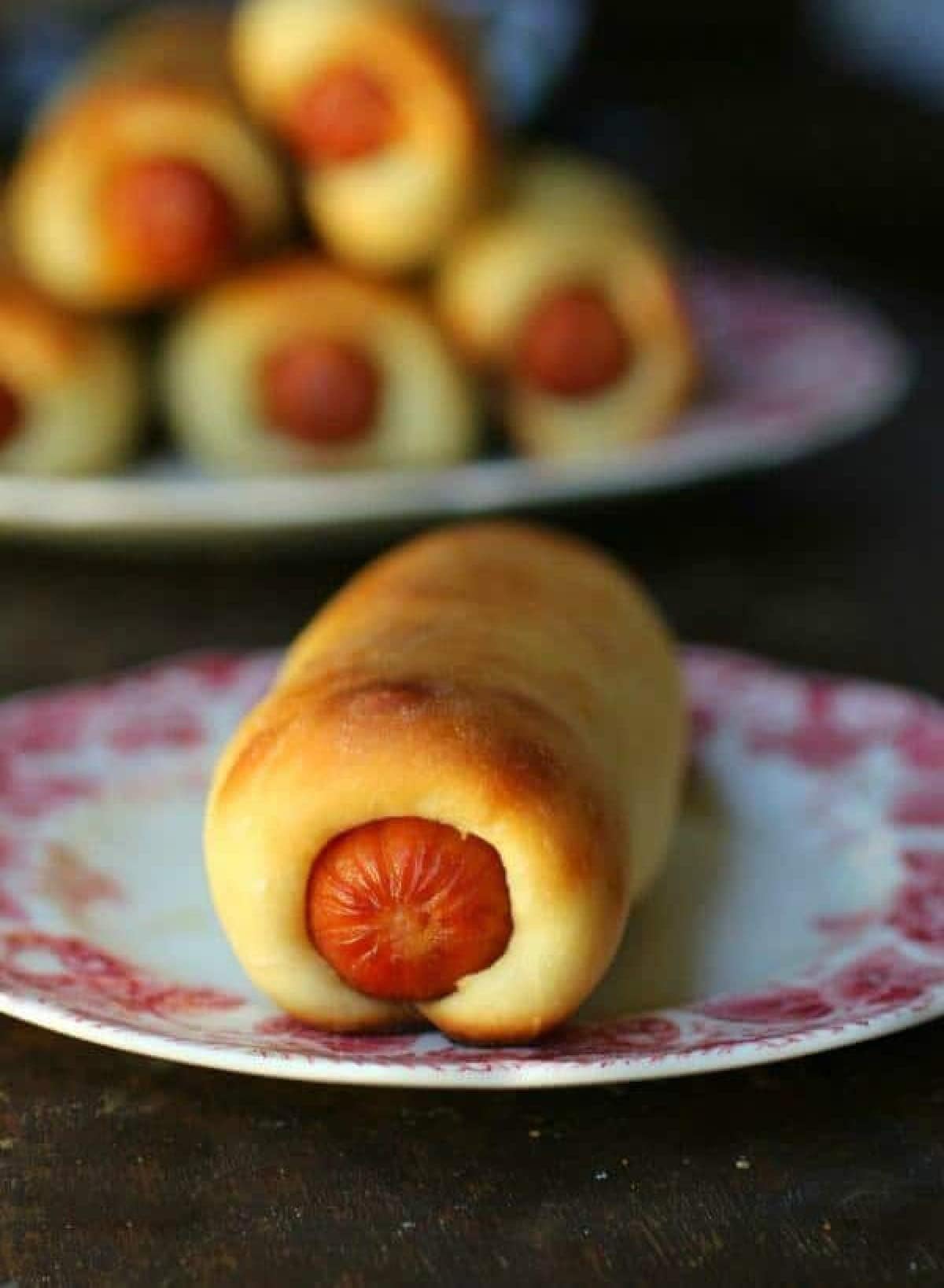 A sausage kolache on a plate.