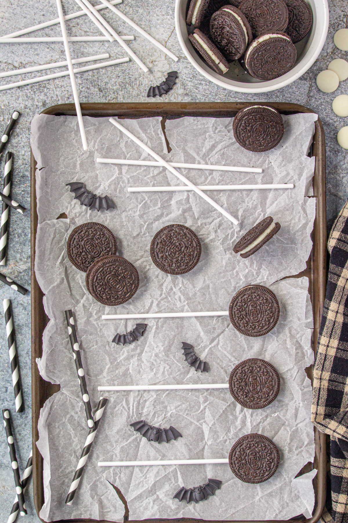 Adding the lollipop sticks to the Oreo pops.