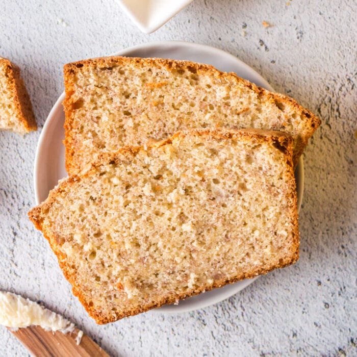 Banana bread slices on a white plate.