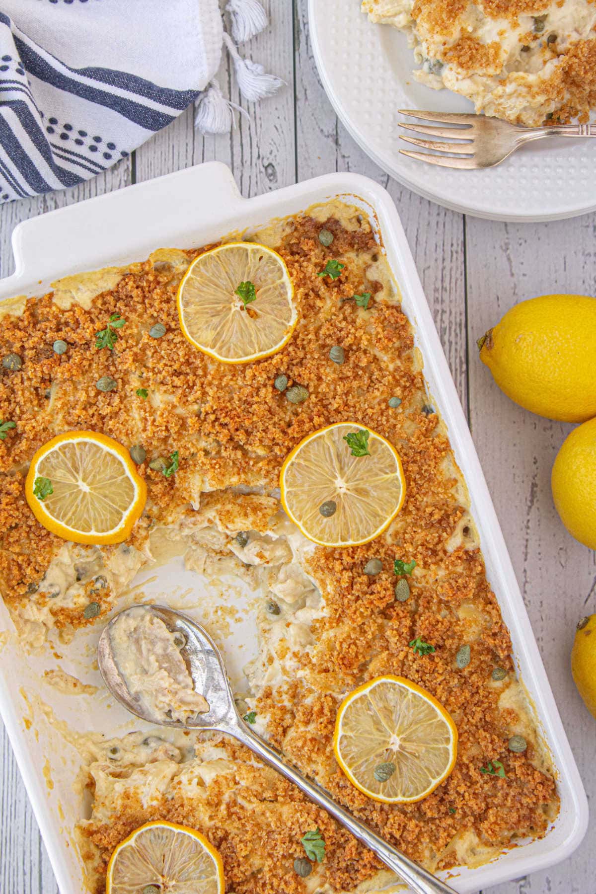 Overhead view of chicken piccata casserole garnished with lemon slices.