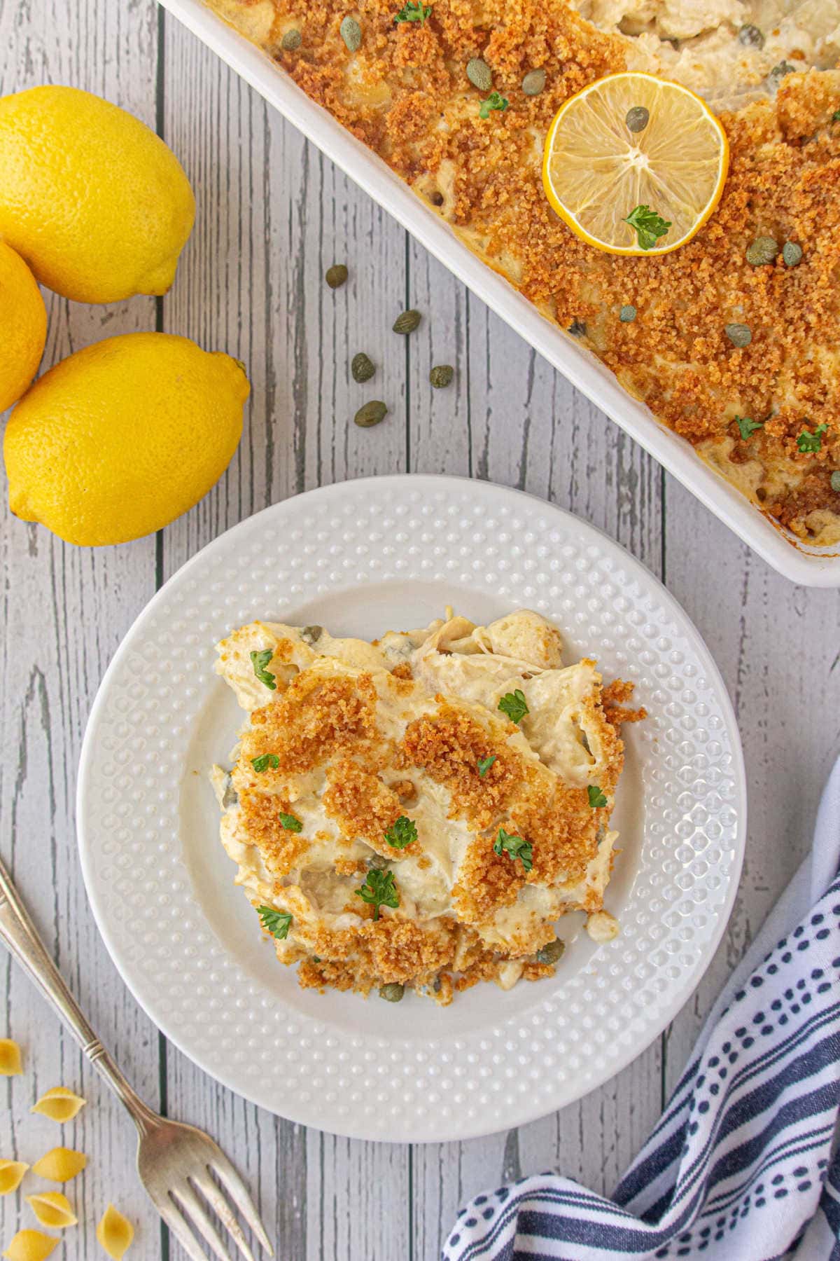 Overhead view of chicken piccata casserole on a plate showing the crispy buttered breadcrumb topping.