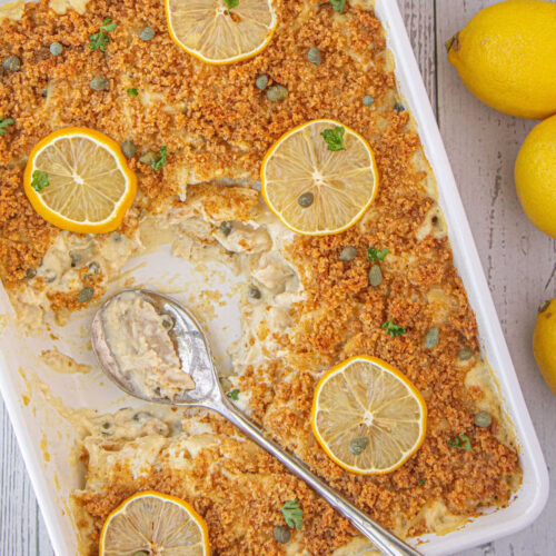 Chicken piccata casserole with a serving spoon resting on top.