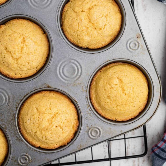 Closeup of cornmeal muffins in the baking tin.