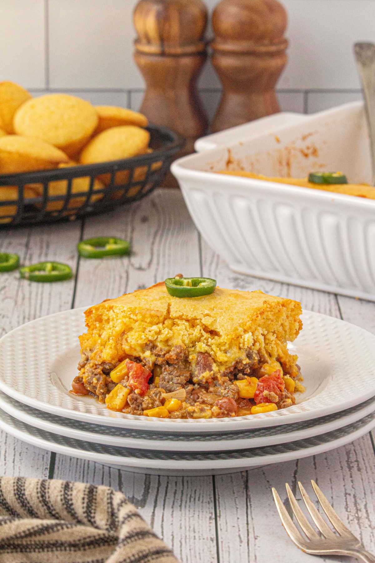 A serving of cornbread and ground beef casserole on a plate.