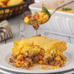 A forkful of the cowboy casserole being lifted up from the plate.