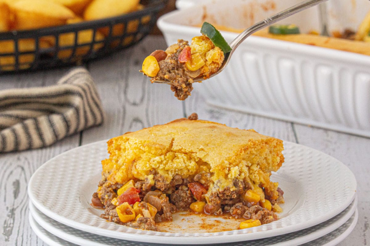 A forkful of the cowboy casserole being lifted up from the plate.