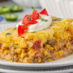 A serving of Jiffy Mexican cornbread casserole on a plate.